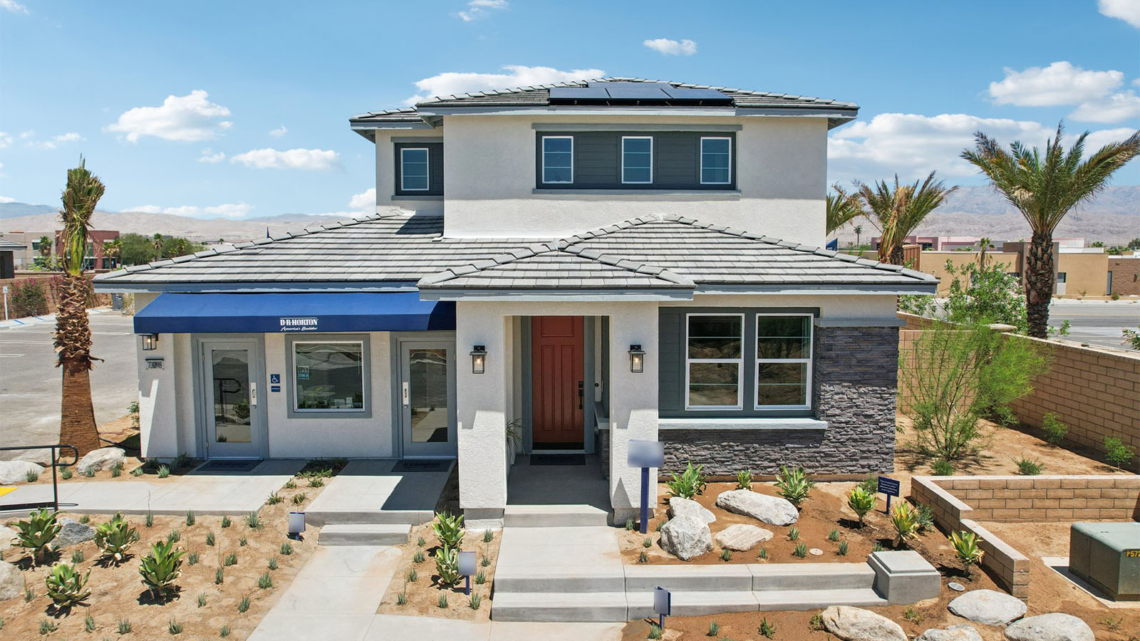 Two-story Desert Contemporary home with stone veneer and two-car garage