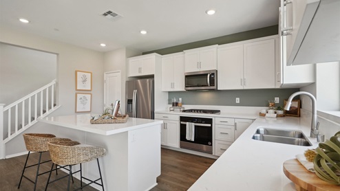 Bright kitchen with white cabinets and an island