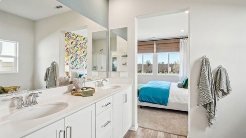 Primary bathroom with white cabinets