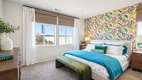 Primary bedroom with large windows looking into backyard