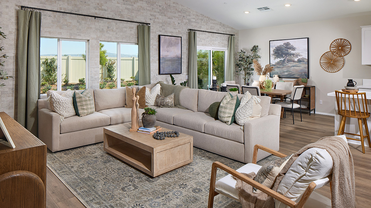 Modern open concept living and dining space with entry to back patio