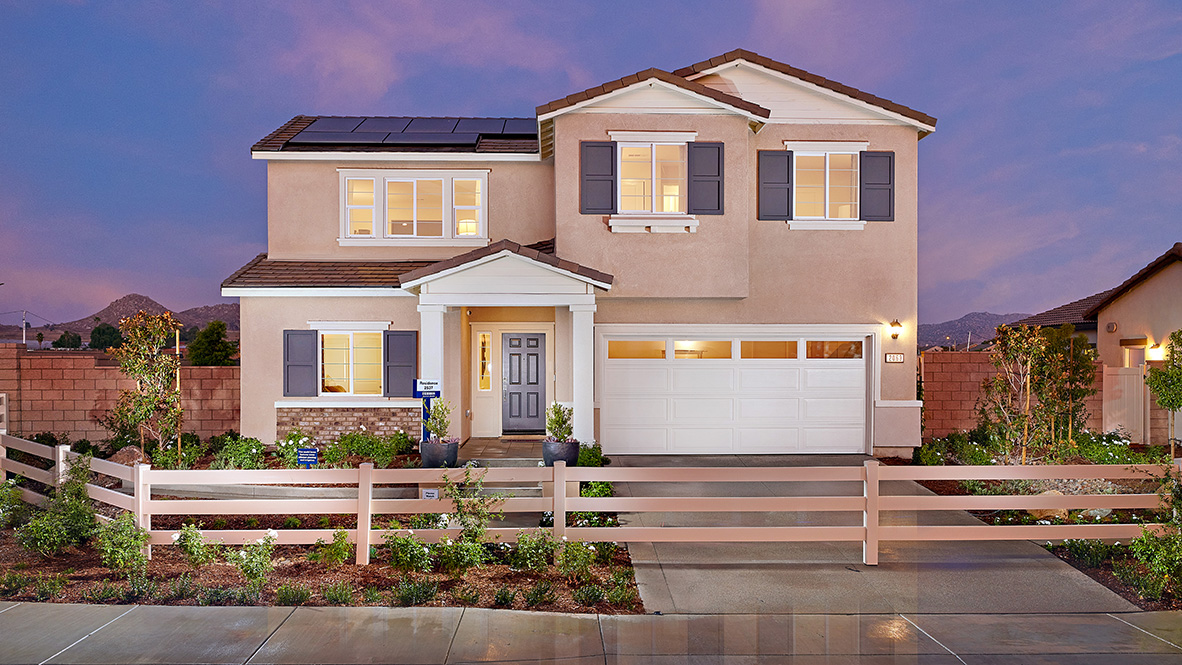 Two story home with a covered entry and 2-car garage