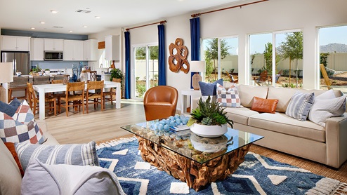 Modern open-concept living and dining area with door to back patio