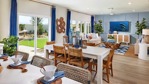 Modern open-concept living and dining area with door to back patio