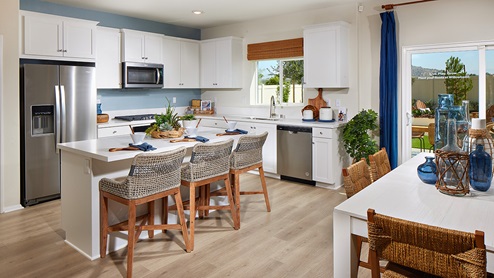 Modern kitchen with white cabinets and stainless steel appliances