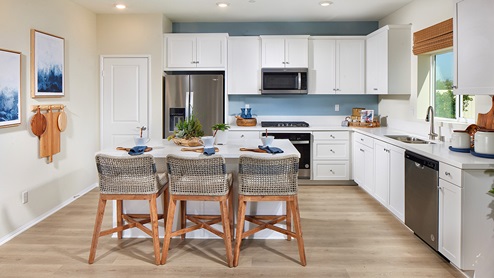 Modern kitchen with white cabinets and stainless steel appliances