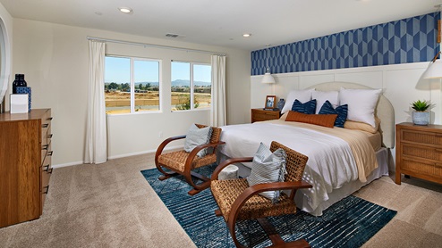 Spacious primary bedroom with large windows