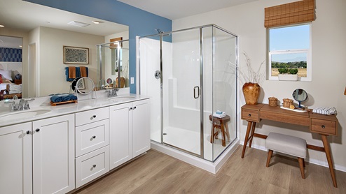 Primary bathroom with white cabinetry and double sinks