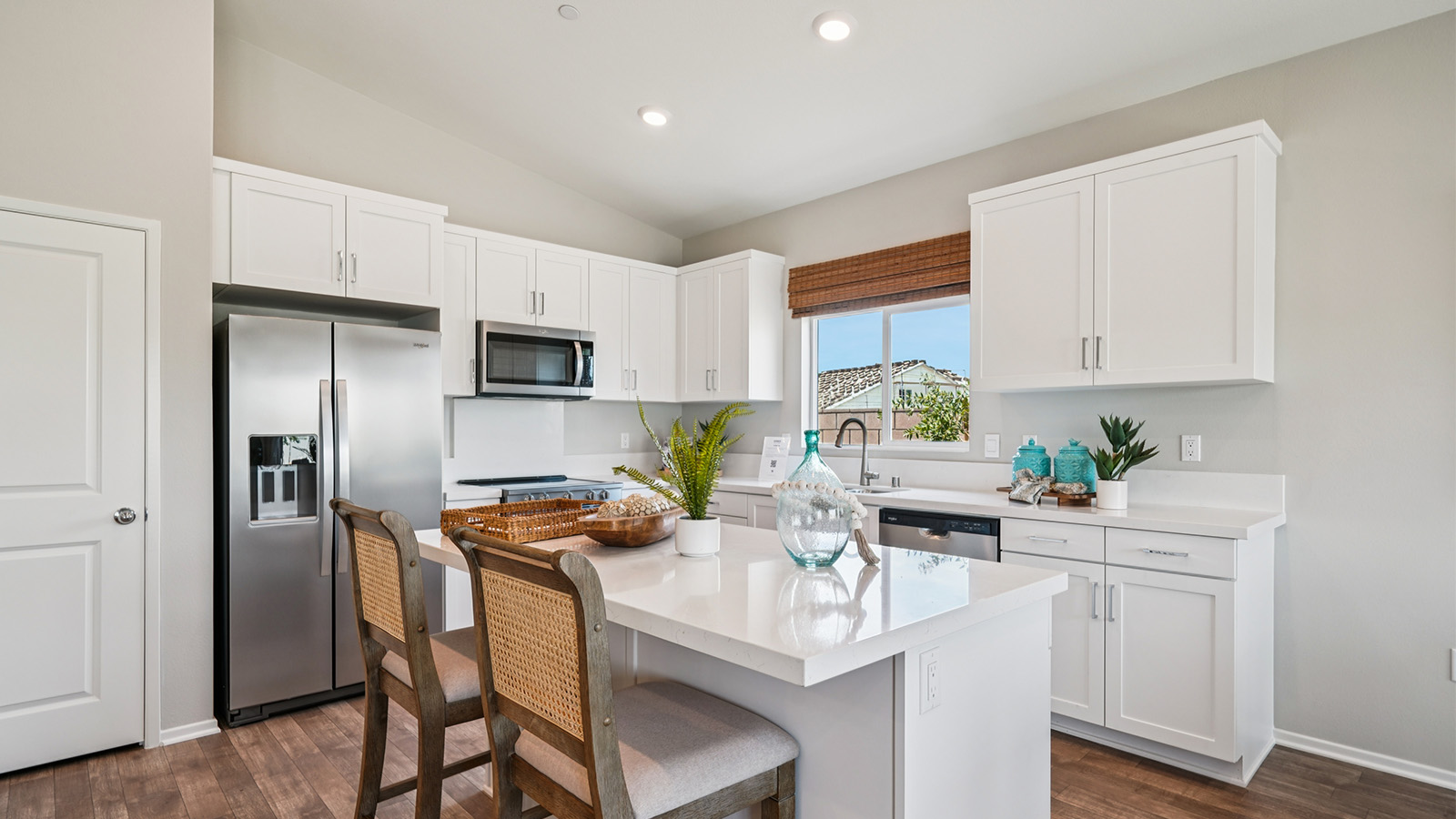 Kitchen with white cabinets and an island in the center
