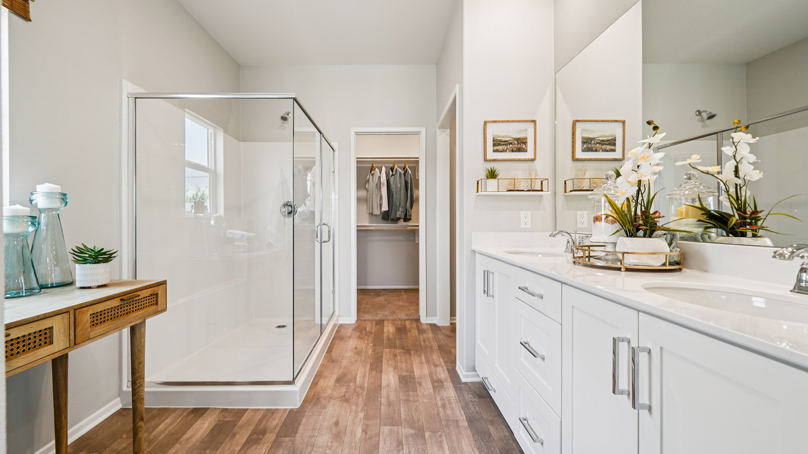 Primary bathroom with dual vanities and shower