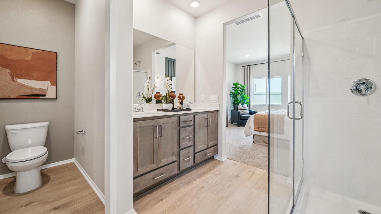 Primary bathroom with dual vanities and shower