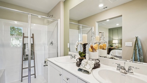Primary bathroom with white cabinets