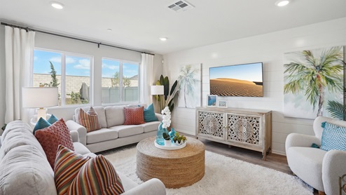 Seating space within the great room next to windows looking into backyard