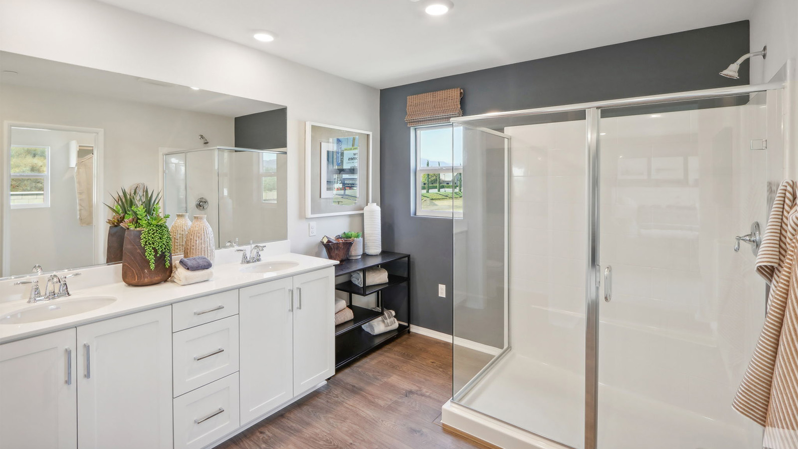 Primary bathroom with white cabinets and stainless steel appliances