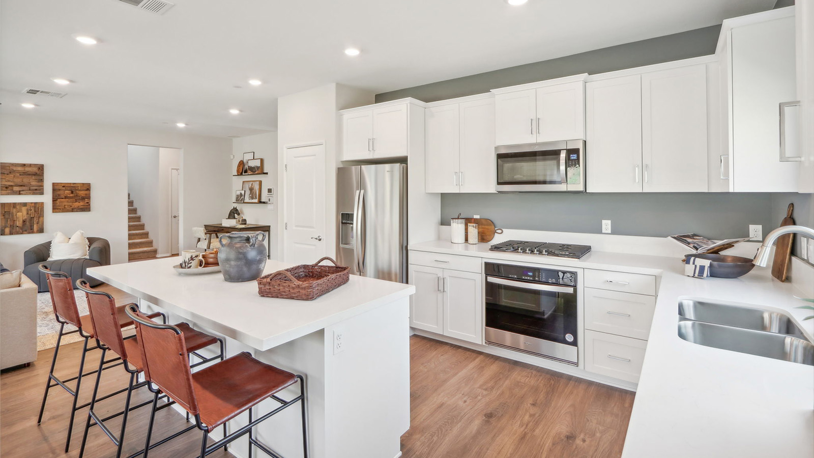 Spacious kitchen with white cabinets and stainless-steel appliances