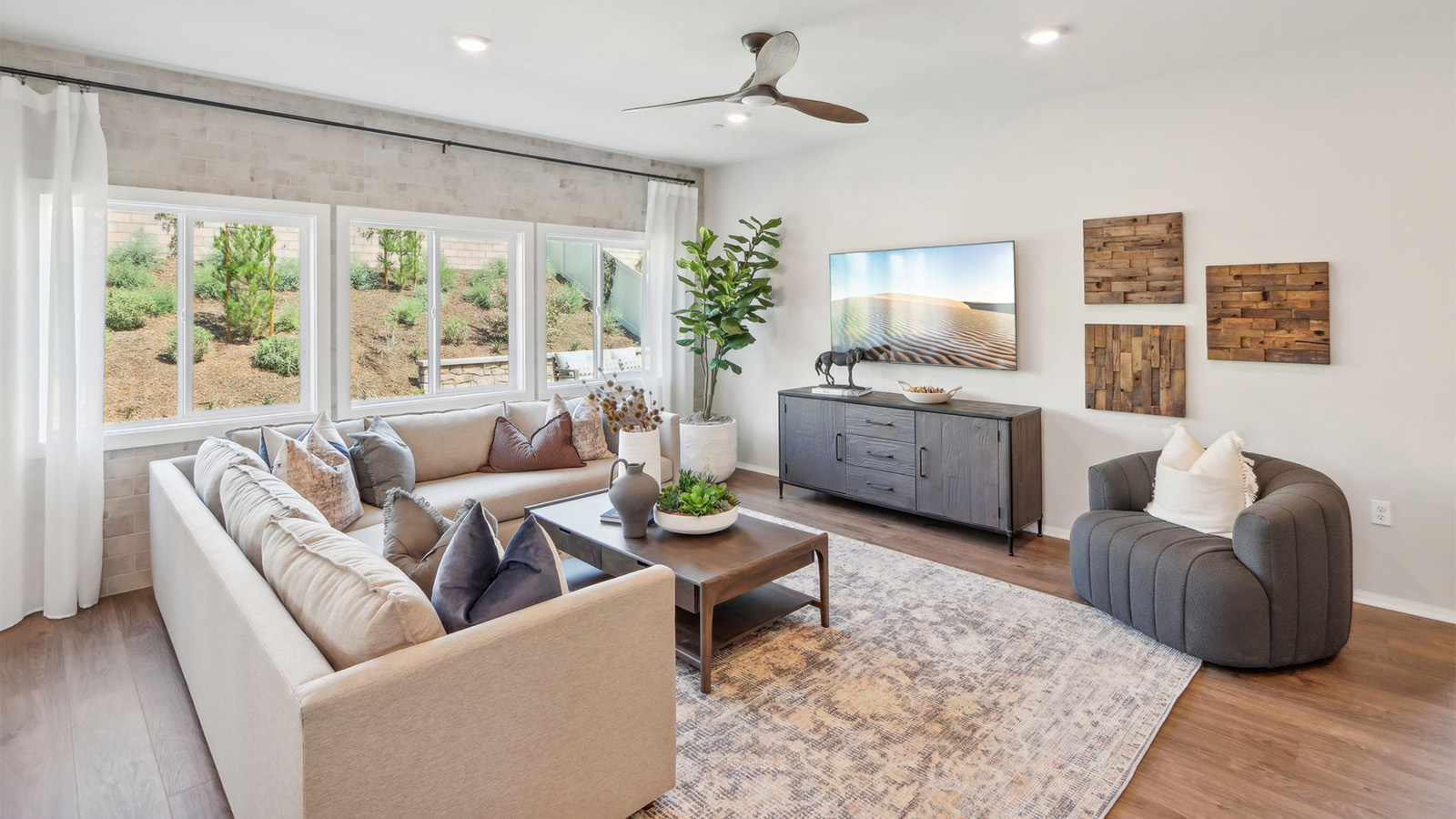 Great room with large windows looking into backyard