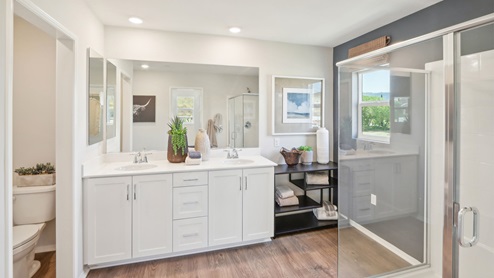 Primary bathroom with white cabinets