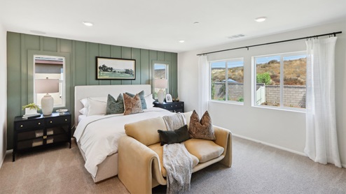Primary bedroom with large windows