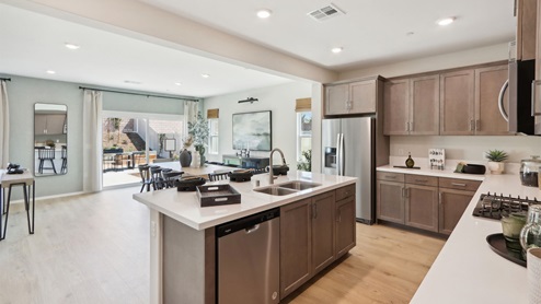 Kitchen with white quartz countertops and stainless steel appliances
