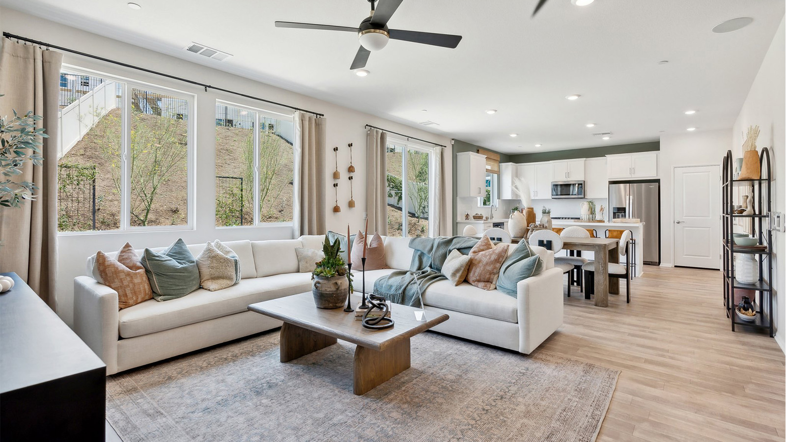 Open-concept living space with windows looking out to patio