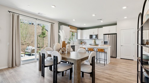 Open and bright kitchen with white cabinets and stainless-steel appliances