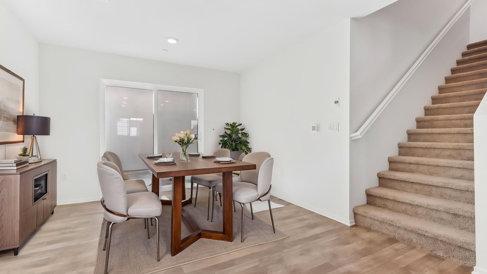 virtually staged dining room with slider to outside