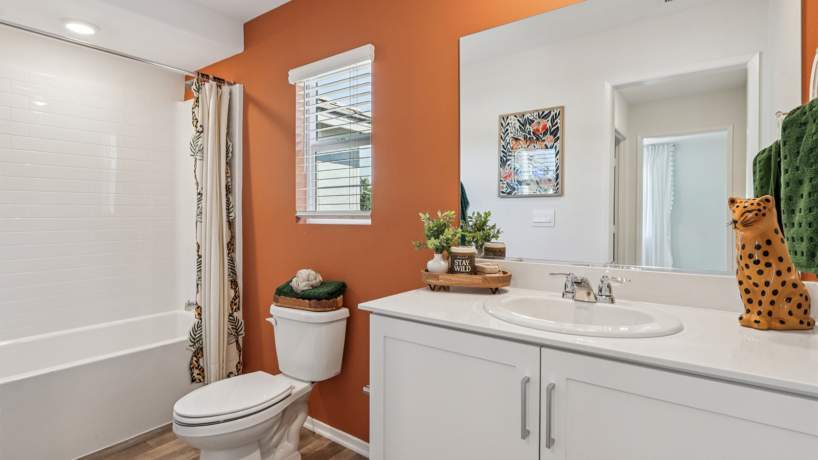 Secondary bathroom with white cabinets