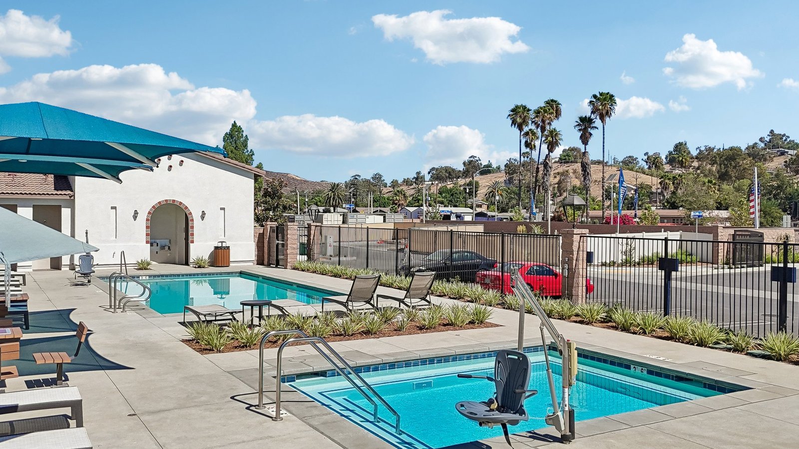 Community Pool with lounge chairs and restroom building