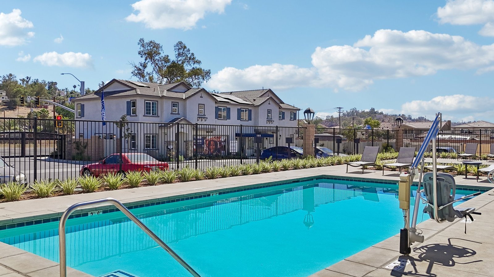 Community Pool with lounge chairs and restroom building