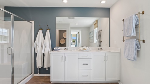 Primary bathroom with white cabinets