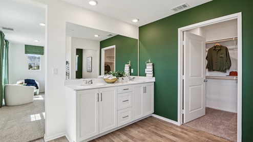 Primary bathroom with white cabinets and double sinks