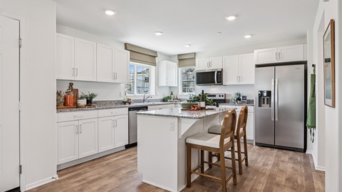 Kitchen with white cabinets and granite countertops and an island