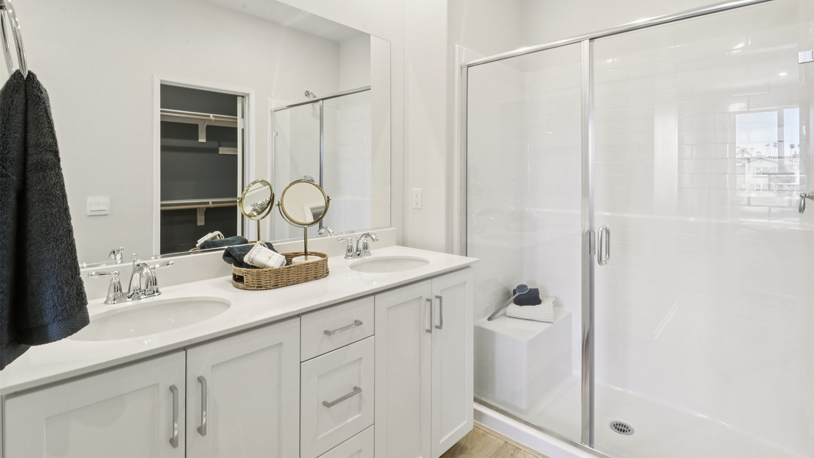 Primary bathroom with double sinks and white cabinetry