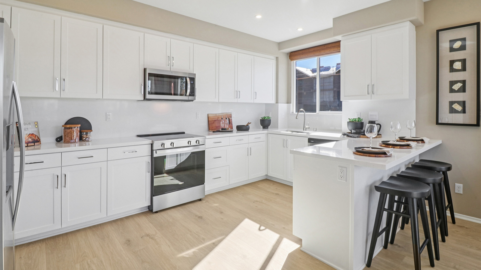 Kitchen with white cabinets and a peninsula island