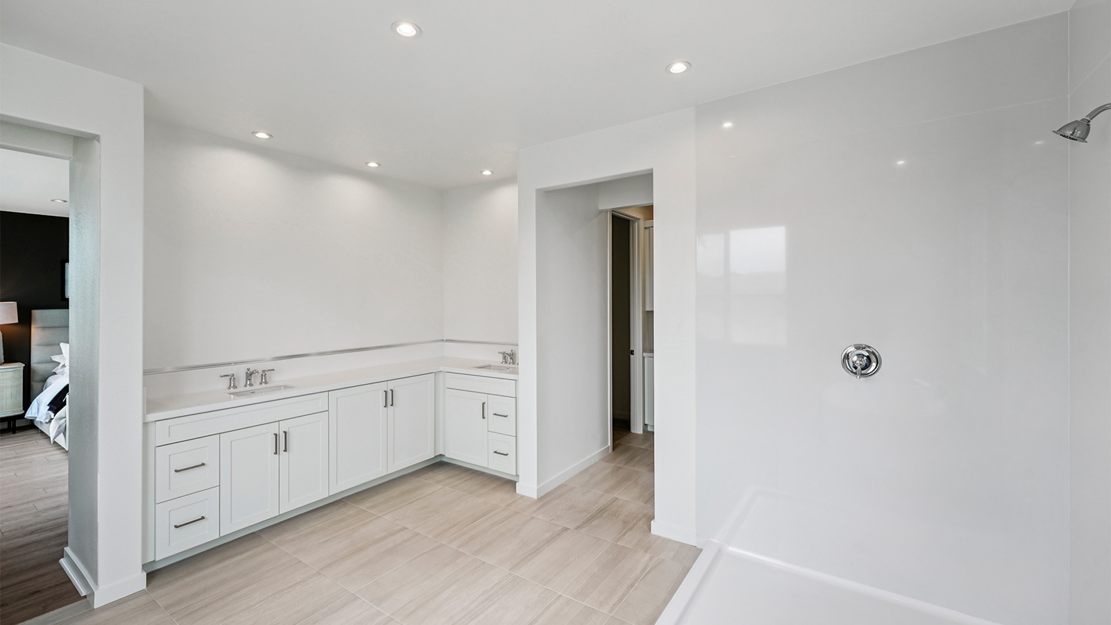 Primary bathroom with white cabinets and double sinks