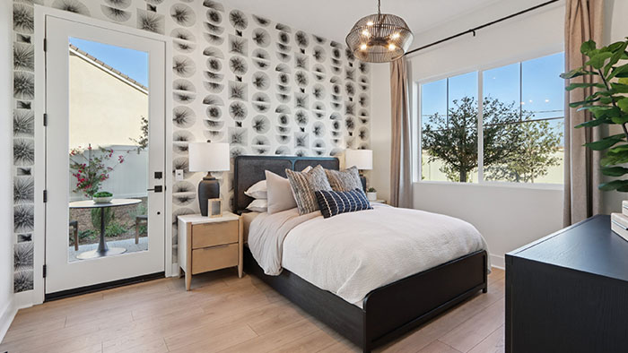 Interior bedroom with accent wall and large windows