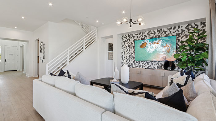 Interior living area with accent wall open to staircase