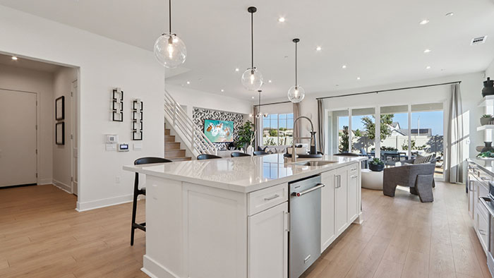 Interior kitchen with center island and white cabinets