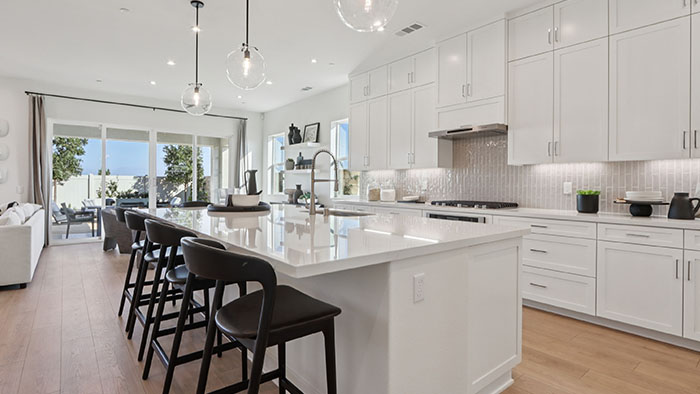 Interior kitchen with center island and white cabinets
