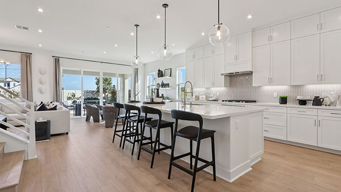 Interior kitchen with center island and white cabinets