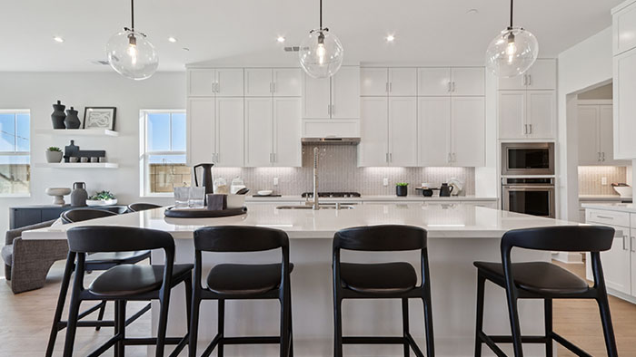 Interior kitchen with center island and white cabinets