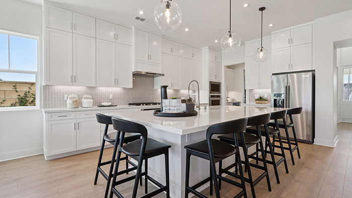 Interior kitchen with center island and white cabinets