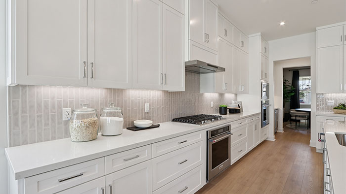 Interior kitchen with center island and white cabinets