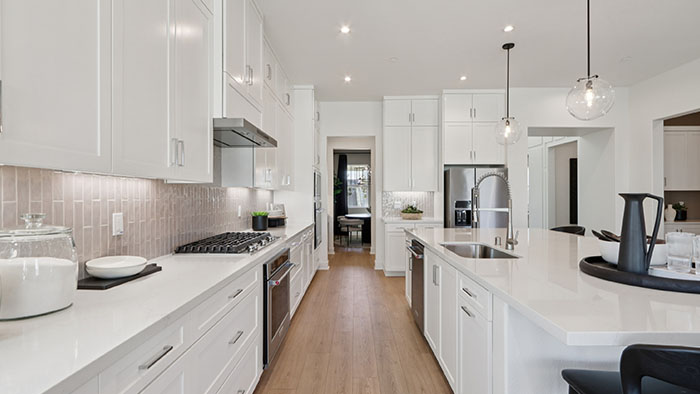 Interior kitchen with center island and white cabinets