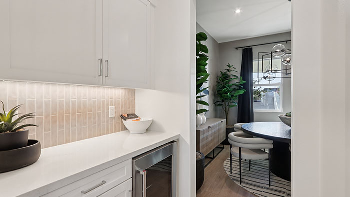 Interior kitchen with center island and white cabinets