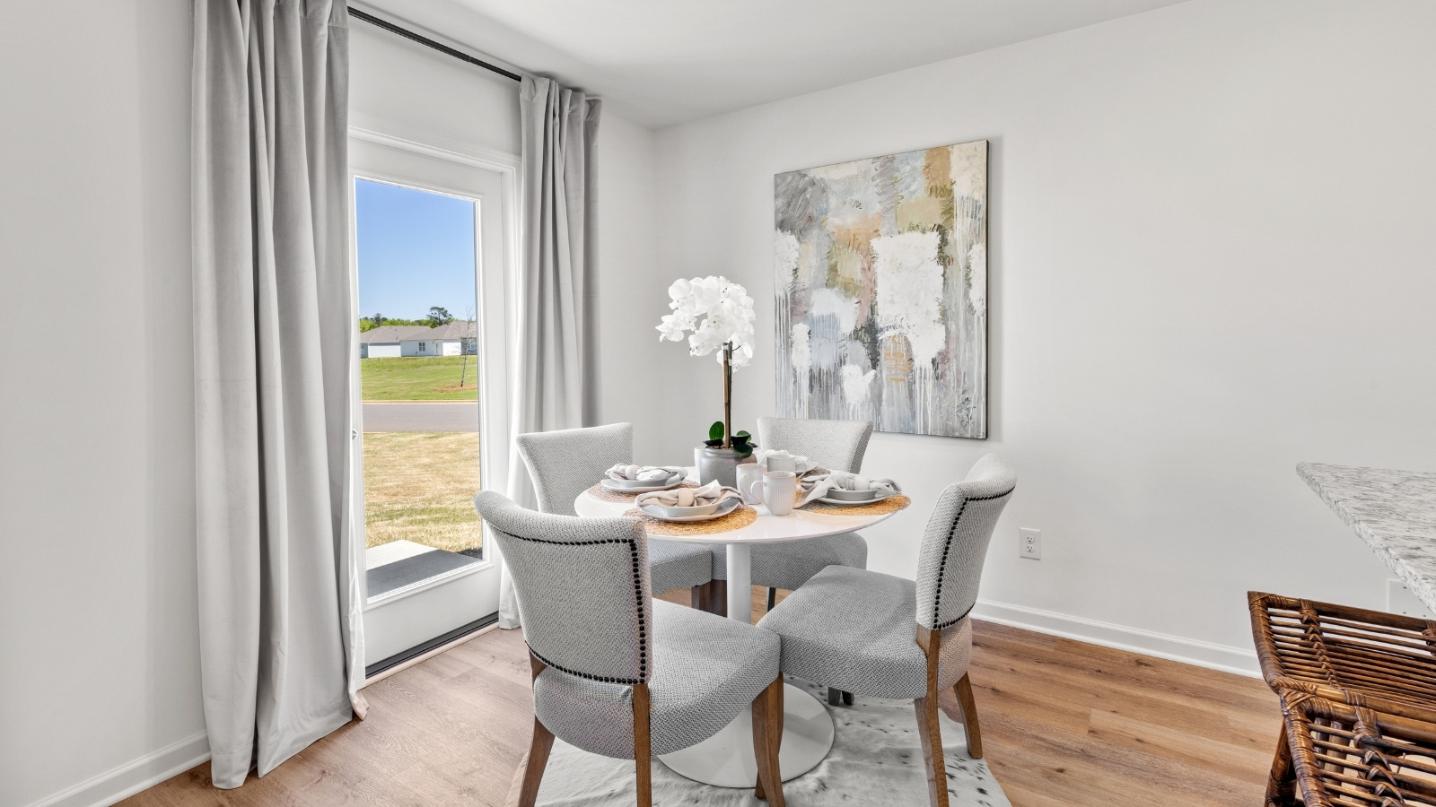The open concept kitchen features a large counter island connected to the wall with granite counter tops and stainless-steel appliances.