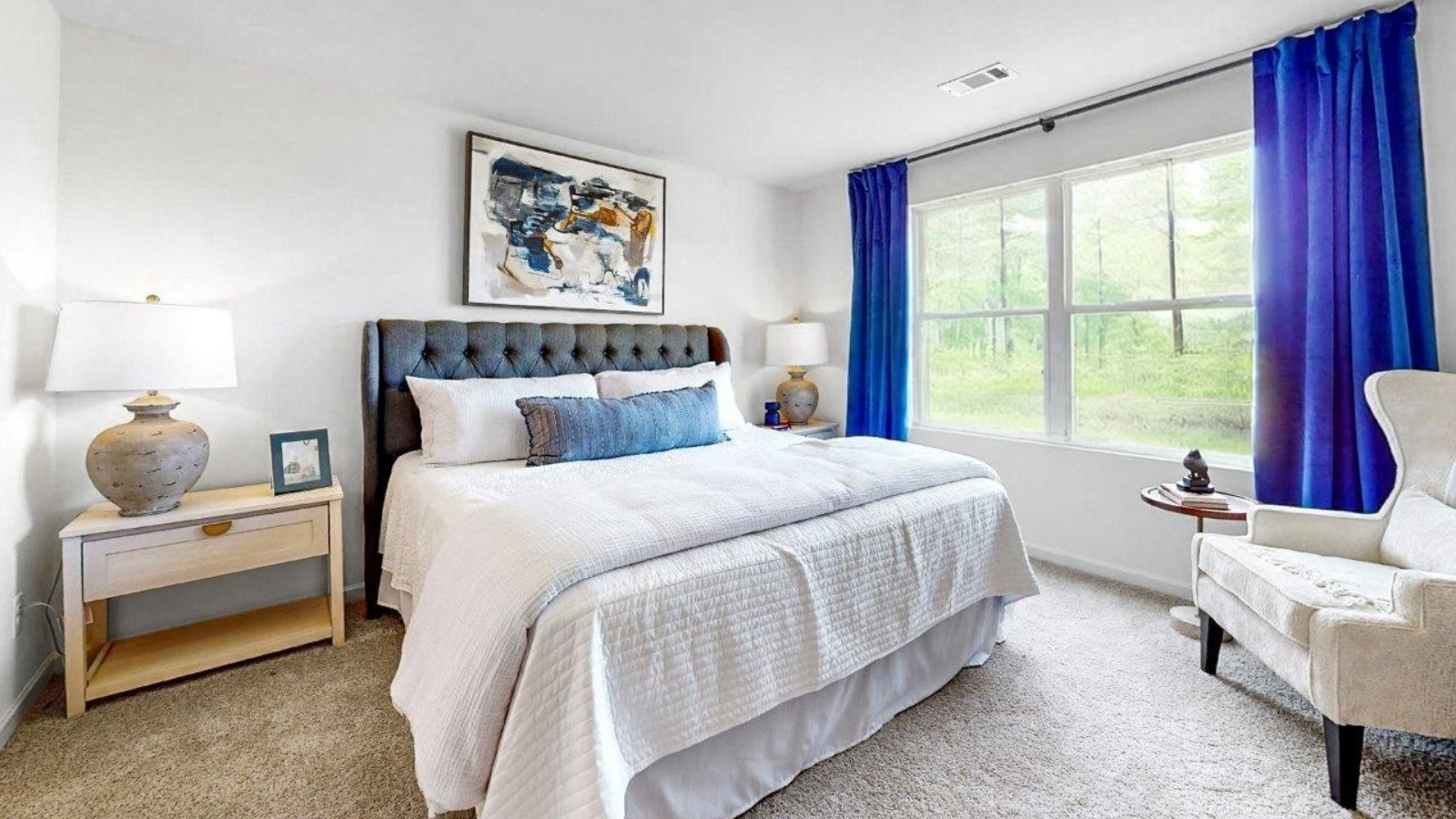 The spacious primary bedroom allows for room for an entire bedroom suite.