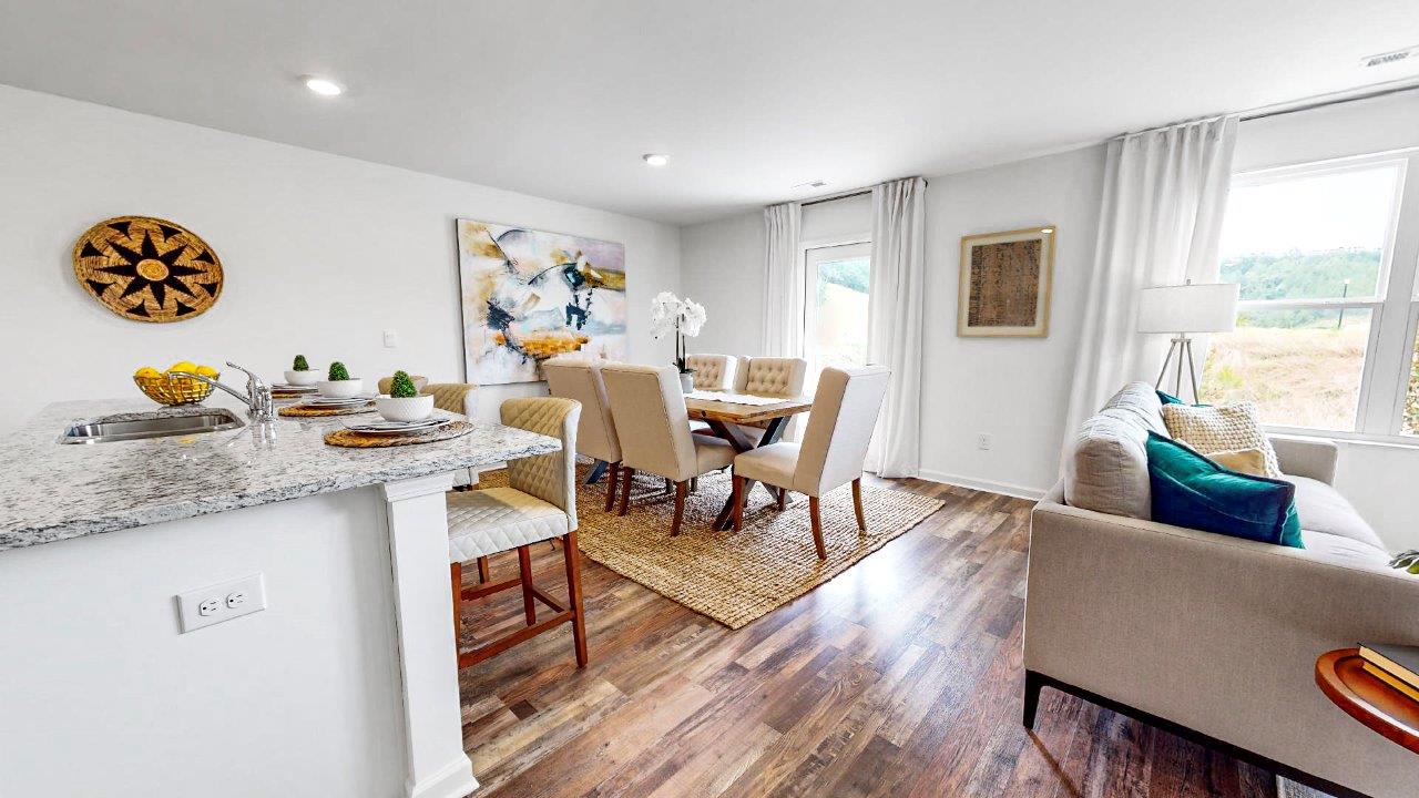 Large dining area that holds a large kitchen table and 6 chairs that opens to the kitchen