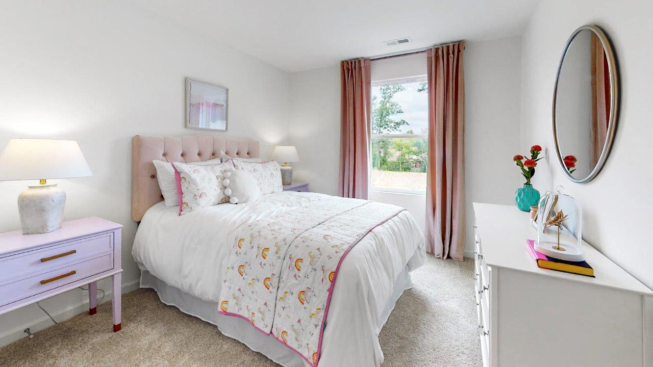 11.	Taylor – Bedroom 3 – a third bedroom with a white bed and a purple dresser with two nightstands and lamps