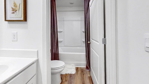 14.	Taylor – Bathroom 2 – 2 – A bathroom with a door that separates the two sinks from the toilet and tub/shower